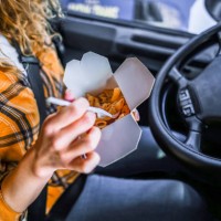 female truck driver eating on lunch break in truck's cabins - junk food stock pictures, royalty-free photos & images