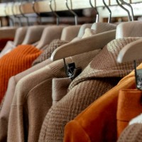 females elegant and casual clothes are neatly hung by color, systematization of clothes. shopping fashion sale background. colorful clothes on hangers. selective focus - fashion stock pictures, royalty-free photos & images