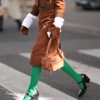 Fer Millán Delaroière is seen wearing a matching two-piece in brown suede from Miu Miu, consisting of a cropped jacket with ribbed trims, a black...
