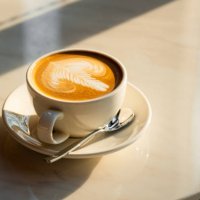 feshly brewed latte coffee on a white table - coffee stock pictures, royalty-free photos & images
