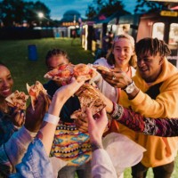 festival goers sharing pizza - food stock pictures, royalty-free photos & images
