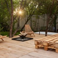 fire place on the wooden veranda next to chairs in garden - garden decoration stock pictures, royalty-free photos & images