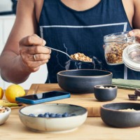 fit & healthy man making oatmeal for breakfast - food stock pictures, royalty-free photos & images