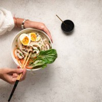 flat lay of noodle bowls with hands - food stock pictures, royalty-free photos & images