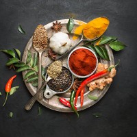 flat lay overhead view herb and spices on textured black background. - food stock pictures, royalty-free photos & images