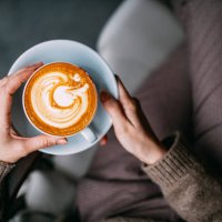 flat lay woman hand holding coffee latte - coffee stock pictures, royalty-free photos & images