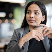 flexible working anywhere for young business entrepreneur. portrait of confident young businesswomen holding a coffee cup while working in a lobby hotel during business trip. - junk food stock pictures, royalty-free photos & 