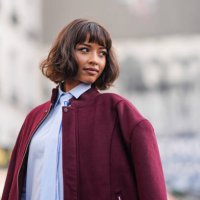 Flora Coquerel wears a burgundy oversized bomber jacket , a pastel pale blue long shirt / midi dress with a tie, outside Casablanca, during the...