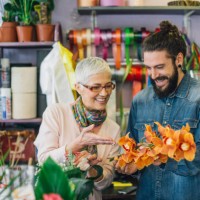 florist and a young man making a flower arrangement - garden decoration stock pictures, royalty-free photos & images