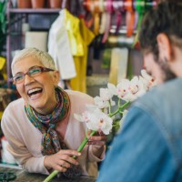 florist laughing with a customer in a flower shop - garden decoration stock pictures, royalty-free photos & images