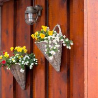 flowers in wicker pots on a icelandic wooden house - garden decoration stock pictures, royalty-free photos & images