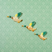 flying duck ornaments on wallpapered wall - home decoration stock pictures, royalty-free photos & images