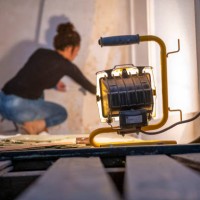 focused diy enthusiast paints a wall in a room undergoing renovation - home decoration stock pictures, royalty-free photos & images