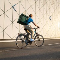 food delivery person riding bicycle, delivering food - food stock pictures, royalty-free photos & images