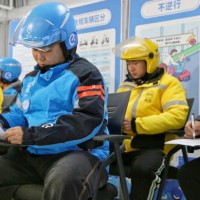 Food delivery riders take a training test on traffic regulations in Hai 'an city, Jiangsu province, China, November 30, 2023.