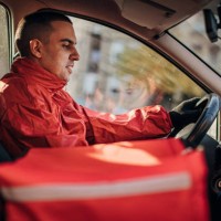 food delivery riding in a car - junk food stock pictures, royalty-free photos & images