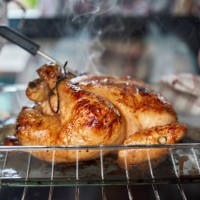 food safety - roasting chicken in the oven with digital thermometer - food stock pictures, royalty-free photos & images