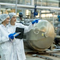 food scientist, nutritionist or quality control officer wear a hair net and sterile clothing. check the quality of beverage products in the production line - food stock pictures, royalty-free photos & images