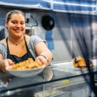 food service worker holding a plate of salad with gyros at a diner - junk food stock pictures, royalty-free photos & images