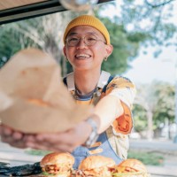 food truck owner picks up the burger - junk food stock pictures, royalty-free photos & images