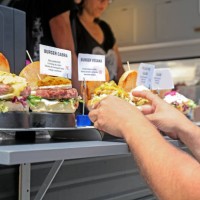 food truck owner serving burger - junk food stock pictures, royalty-free photos & images