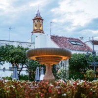 fountain with flowers in the town square of estepona, malaga, spain at sunset - garden decoration stock pictures, royalty-free photos & images