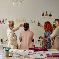 four female coworkers working on their fashion design - fashion stock pictures, royalty-free photos & images