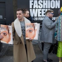 Free magazines featuring a model's eye on the cover are being handed out on the first day of London Fashion Week, in the Strand, on 16th february...