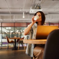freelance woman working at laptop in coworking - junk food stock pictures, royalty-free photos & images