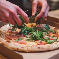 fresh arugula on a pizza - junk food stock pictures, royalty-free photos & images