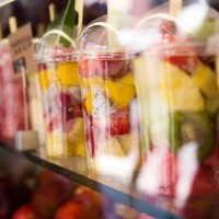 fresh colorful fruit salad in plastic packaging on street market - junk food stock pictures, royalty-free photos & images