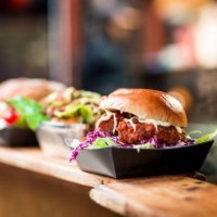fresh crispy pork burgers in a row at food market - junk food stock pictures, royalty-free photos & images