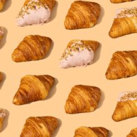 fresh croissant against a pastel peach background - food stock pictures, royalty-free photos & images