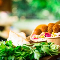 fresh falafel and salad on display at vegan vegetarian stall at food market - junk food stock pictures, royalty-free photos & images