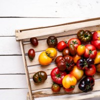 fresh organic colorful heirloom and cherry tomatoes on rustic background, high angle view - garden decoration photos et images de collection