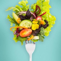 fresh salad on a fork. - food stockfoto's en -beelden