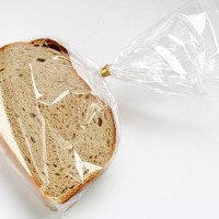 fresh sliced bread in transparent plastic folie on white - food stock pictures, royalty-free photos & images
