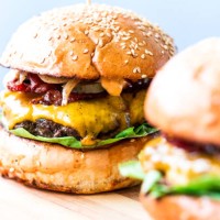 freshly flame grilled bacon cheese burgers in row - junk food stock pictures, royalty-free photos & images