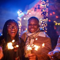 friends at the new year's eve concert dancing and waving sparklers - concert stock pictures, royalty-free photos & images