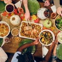 friends celebrating thanksgiving dinner together - food stock pictures, royalty-free photos & images