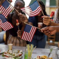 friends dancing and waving american flags during a 4th of july party - food stockfoto's en -beelden