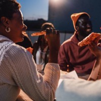 friends dining on a rooftop and having a toast - junk food stock pictures, royalty-free photos & images