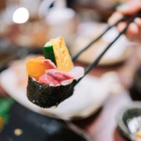friends eating at a japanese restaurant luxury japanese style cuisine with assorted sushi, seafood ,oysters,sashimi freshly served on the dining table in a restaurant. - food stockfoto's en -beelden