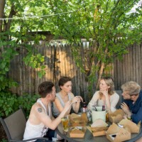 friends eating at a party - junk food stock pictures, royalty-free photos & images