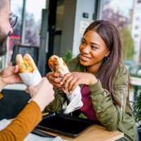 friends eating in a fast food restaurant - junk food stock pictures, royalty-free photos & images