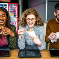 friends eating in fast food restaurant - junk food stock pictures, royalty-free photos & images