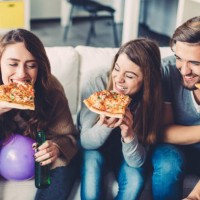friends eating pizza at home - junk food stock pictures, royalty-free photos & images