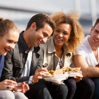 friends eating turkish baked potato near bosphorus bridge in ist - junk food stock pictures, royalty-free photos & images
