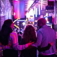 friends embracing at nightlife - including a transgender person - concert stock pictures, royalty-free photos & images