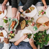 friends enjoying a dinner together in greenhouse harvest party - food stock pictures, royalty-free photos & images